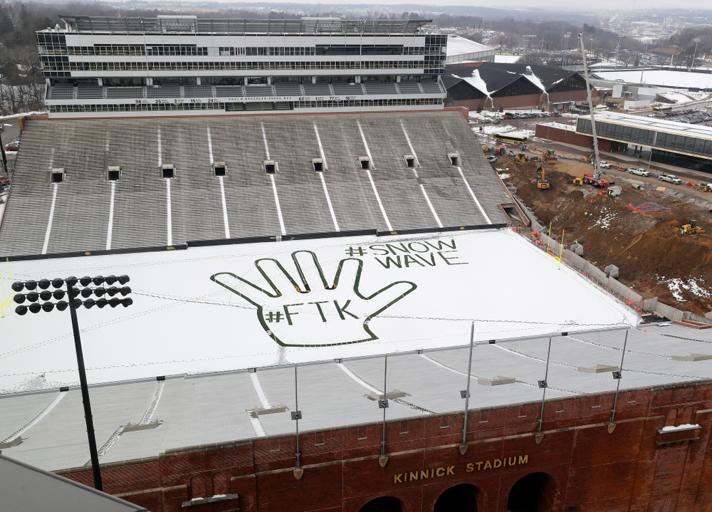 Members of the Iowa Athletics Turf Management staff create the #SnowWave for kids in the Stead Family Children's Hospital Thursday, February