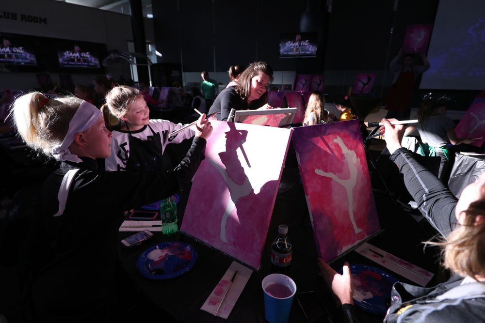 Fans of the GymHawks paint a gymnast with Brush and Barrel before the Iowa Hawkeyes meet against the Minnesota Golden Gophers Saturday, January 19, 2019 at Carver-Hawkeye Arena. (Brian Ray/hawkeyesports.com)