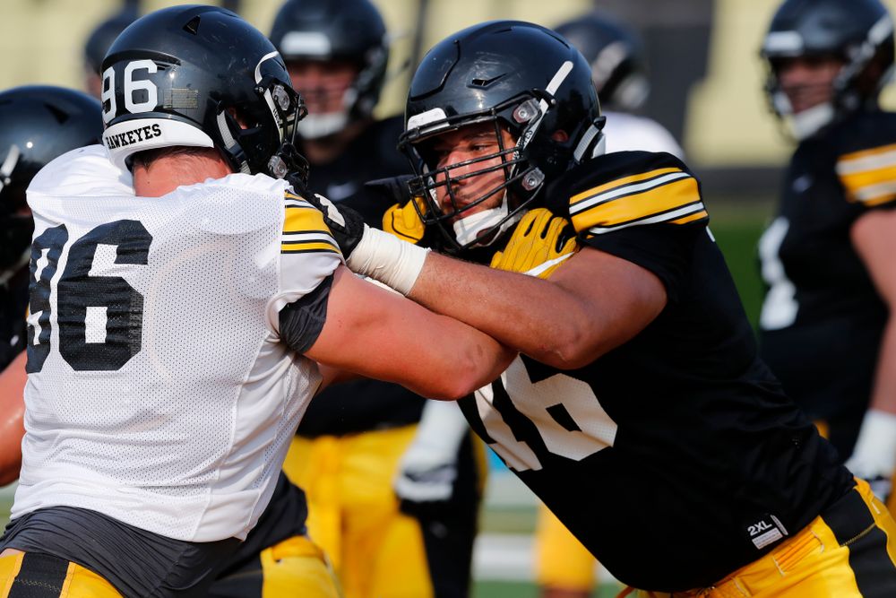 Iowa Hawkeyes offensive lineman Dalton Ferguson (76) and defensive end Matt Nelson (96) during camp practice No. 16 Tuesday, August 21, 2018 at the Hansen Football Performance Center. (Brian Ray/hawkeyesports.com)