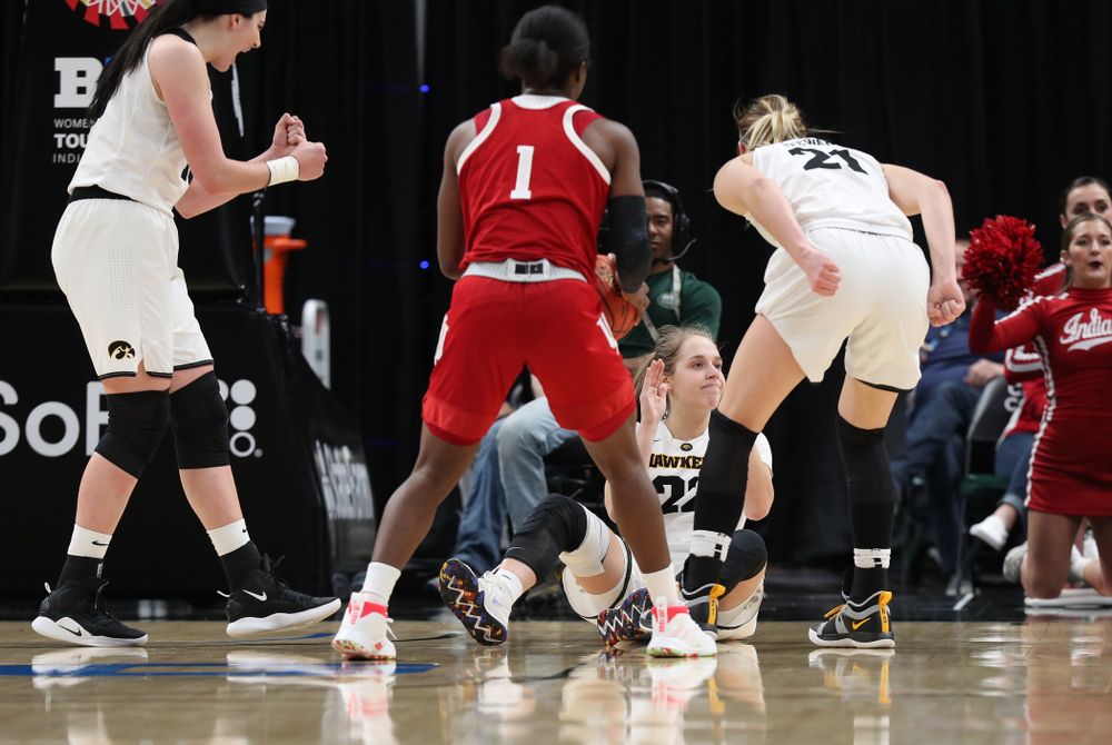 Iowa Hawkeyes guard Kathleen Doyle (22) draws a charging foul against the Indiana Hoosiers in the quarterfinals of the Big Ten Tournament Friday, March 8, 2019 at Bankers Life Fieldhouse in Indianapolis, Ind. (Brian Ray/hawkeyesports.com)