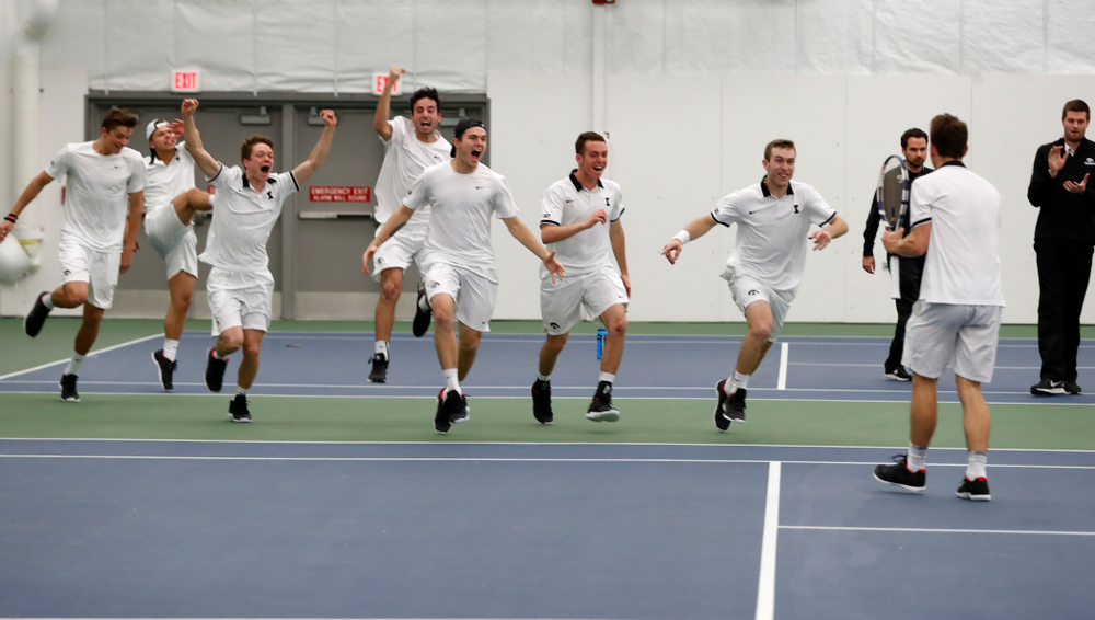 Iowa's Piotr Smietana celebrates with his teammates after clinching the match against Purdue Sunday, April 15, 2018 at the Hawkeye Tennis an