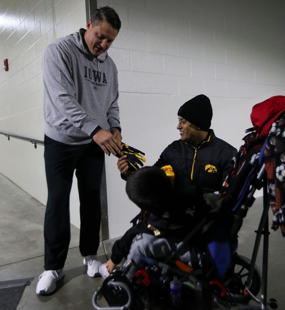 Iowa Hawkeyes offensive coordinator Brian Ferentz meets with Kid Captain Mason Gonzalez before a game against Northwestern at Kinnick Stadium on November 10, 2018. (Tork Mason/hawkeyesports.com)