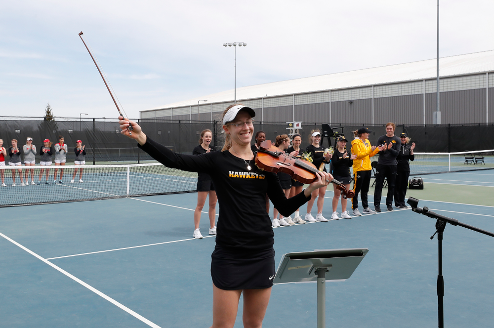 Iowa senior Montana Crawford plays the National Anthem before their match against the Wisconsin Badgers Sunday, April 22, 2018 at the Hawkeye Tennis and Recreation Center. (Brian Ray/hawkeyesports.com)