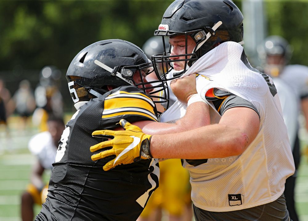 Iowa Hawkeyes offensive lineman Jeff Jenkins (75) and defensive end Logan Lee (85) run a drill during Fall Camp Practice No. 10 at the Hansen Football Performance Center in Iowa City on Tuesday, Aug 13, 2019. (Stephen Mally/hawkeyesports.com)