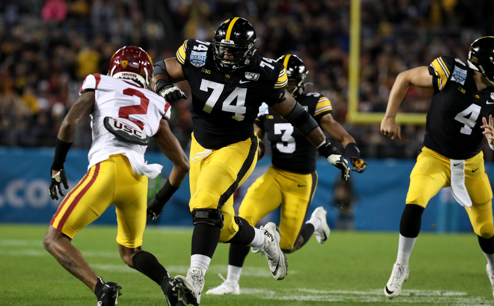 Iowa Hawkeyes offensive lineman Tristan Wirfs (74) blocks for wide receiver Tyrone Tracy Jr. (3) on his way to a touchdown against USC in the Holiday Bowl Friday, December 27, 2019 at San Diego Community Credit Union Stadium. (Brian Ray/hawkeyesports.com)