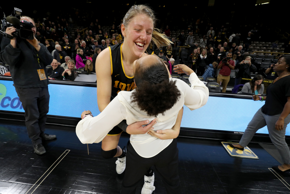 Iowa Hawkeyes forward/center Monika Czinano (25) hugs former Hawkeye and Clemson graduate assistant Tania Davis following their game Wednesday, December 4, 2019 at Carver-Hawkeye Arena. (Brian Ray/hawkeyesports.com)