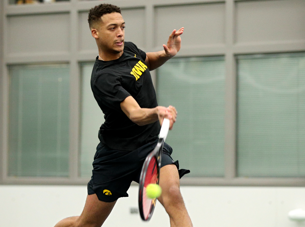 Iowa’s Oliver Okonkwo returns a shot during his singles match at the Hawkeye Tennis and Recreation Complex in Iowa City on Friday, February 14, 2020. (Stephen Mally/hawkeyesports.com)