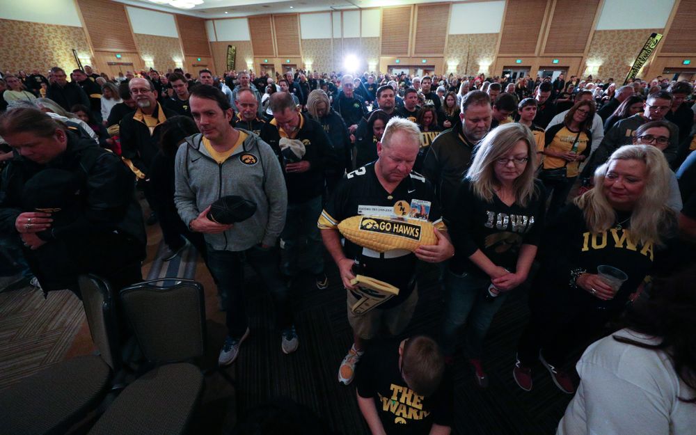Fans pause for a moment of silence honorary Hayden Fry and Bump Elliott during the Holiday Bowl Hawkeye Huddle Thursday, December 26, 2019 at the Hilton in downtown San Diego. (Brian Ray/hawkeyesports.com)