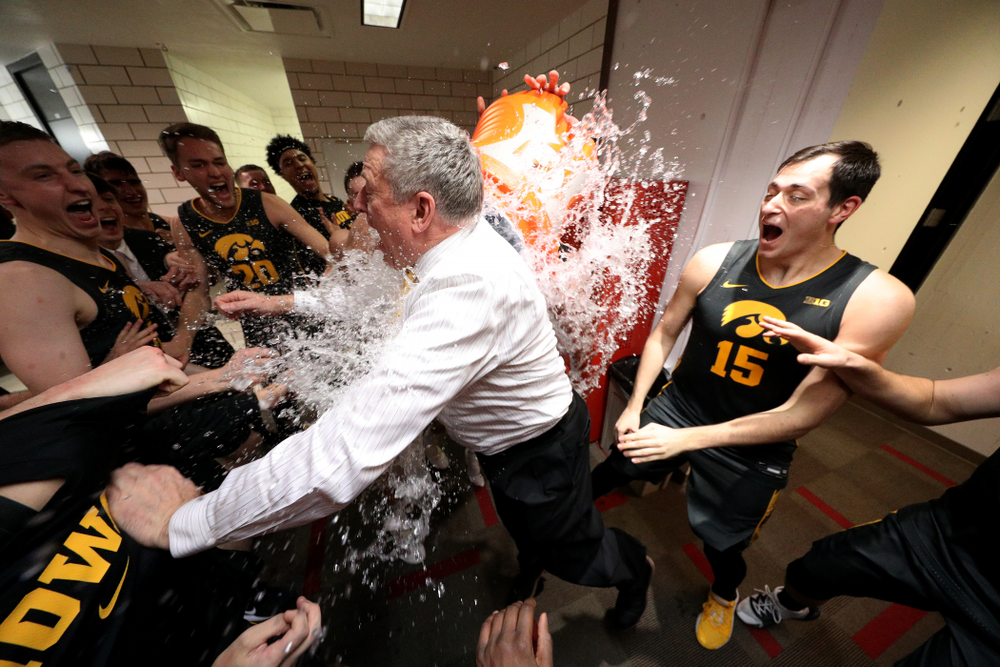 Iowa Hawkeyes assistant coach Kirk Speraw has a bucket of water dumped on him as the Iowa Hawkeyes celebrate their win against the Iowa State Cyclones Thursday, December 12, 2019 at Hilton Coliseum in Ames, Iowa(Brian Ray/hawkeyesports.com)