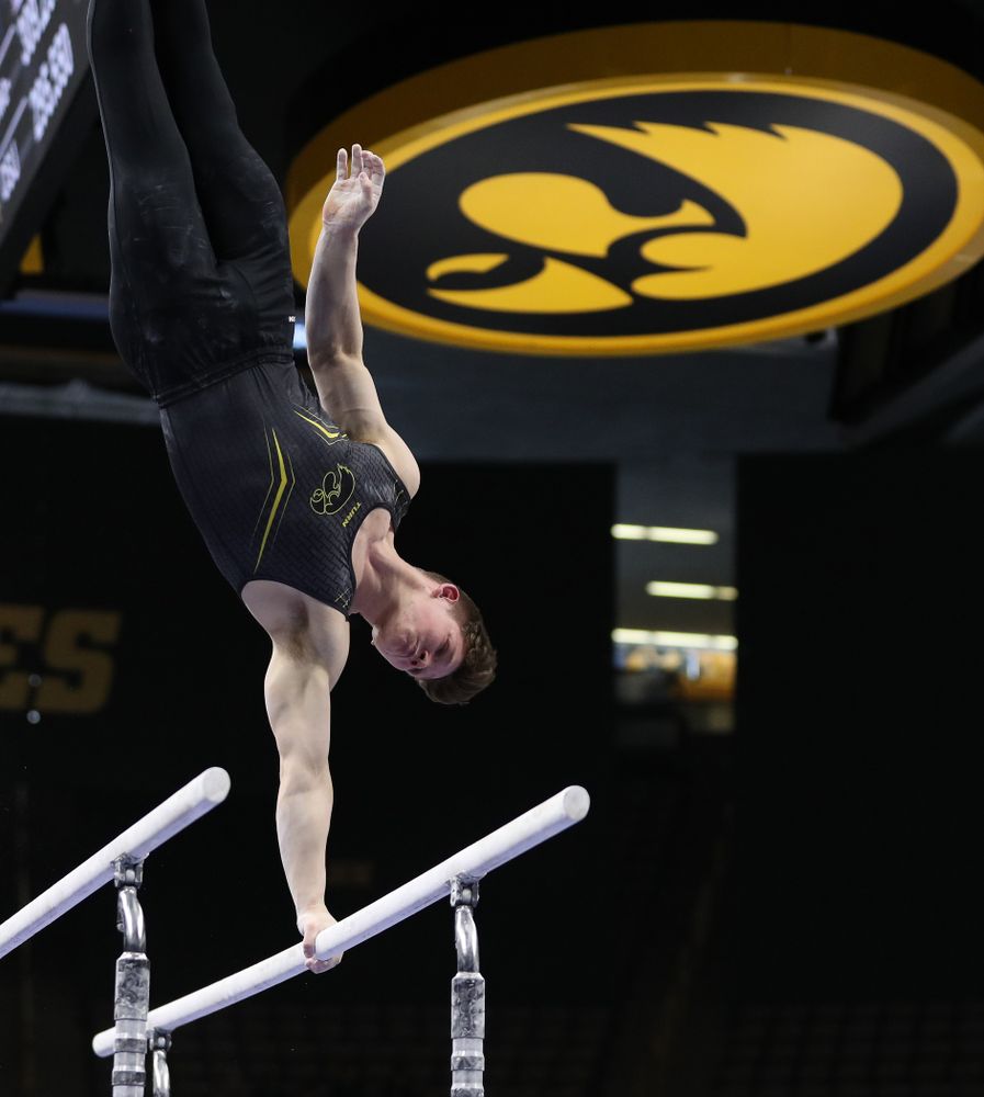 Iowa's Stewart Brown competes on the parallel bars against the Ohio State Buckeyes Saturday, March 16, 2019 at Carver-Hawkeye Arena. (Brian Ray/hawkeyesports.com)