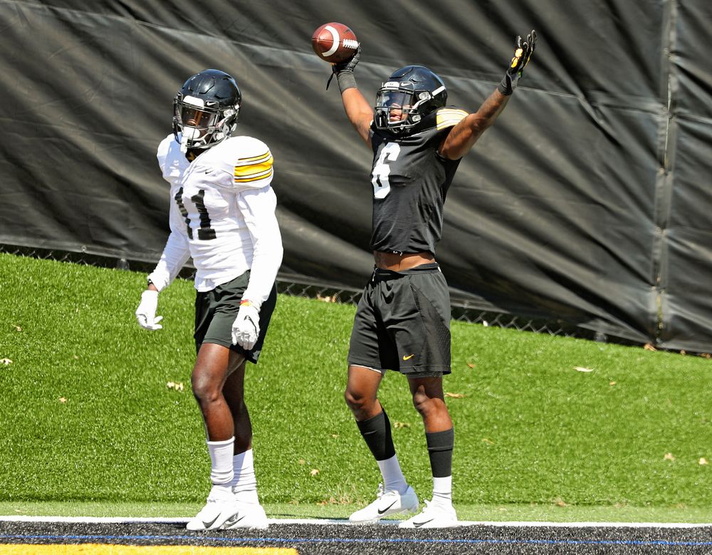Iowa Hawkeyes wide receiver Ihmir Smith-Marsette (6) celebrates after pulling in a touchdown around defensive back Michael Ojemudia (11) during Fall Camp Practice No. 7 at the Hansen Football Performance Center in Iowa City on Friday, Aug 9, 2019. (Stephen Mally/hawkeyesports.com)