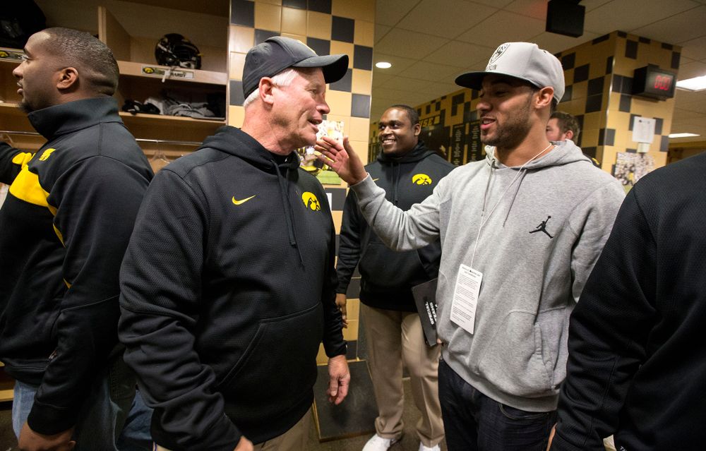 Iowa Hawkeyes defensive line coach Reese Morgan talks with Green Bay Packer Michah Hyde during the second half of their game Saturday, Nov. 1, 2014 at Kinnick Stadium. (Brian Ray/hawkeyesports.com)