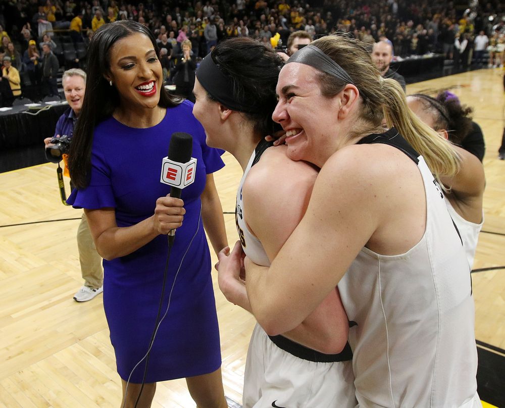 Iowa Hawkeyes center Megan Gustafson (10) is hugged by guard Tania Davis (11) and forward Hannah Stewart (21) as she is interviewed by ESPN's Christy Winters Scott after winning their second round game in the 2019 NCAA Women's Basketball Tournament at Carver Hawkeye Arena in Iowa City on Sunday, Mar. 24, 2019. (Stephen Mally for hawkeyesports.com)