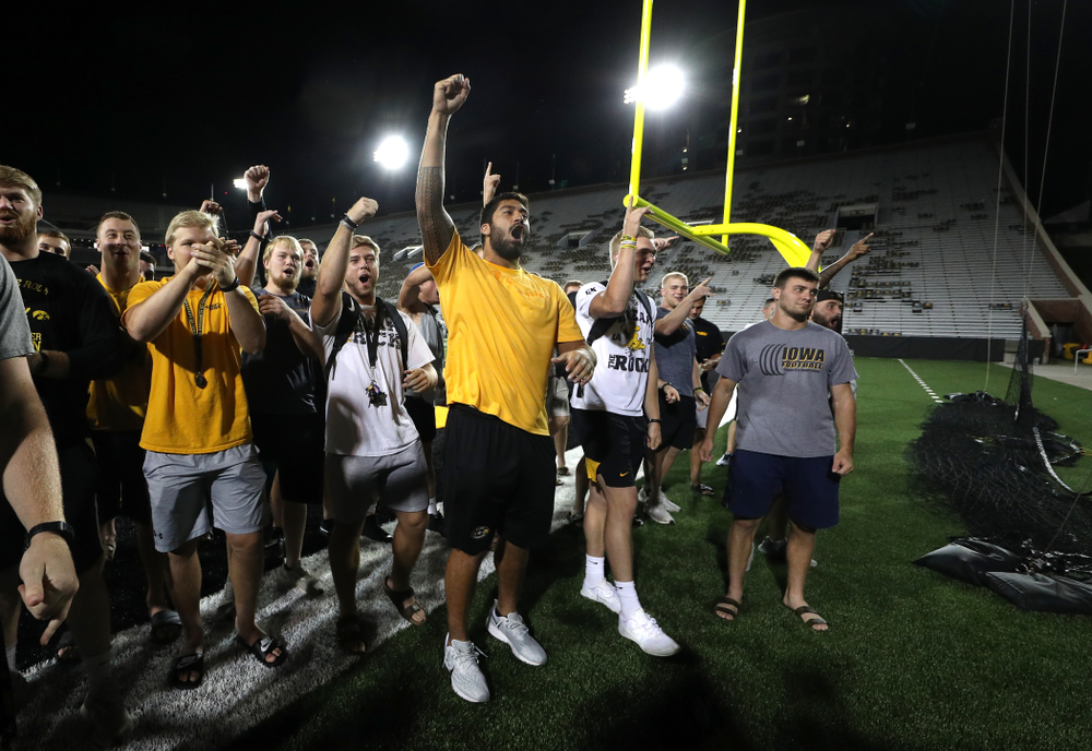 Members o the Iowa Football Team cheer on the new players as they sing the ÒFight SongÓ Thursday, August 22, 2019 at Kinnick Stadium in Iowa City. (Brian Ray/hawkeyesports.com)