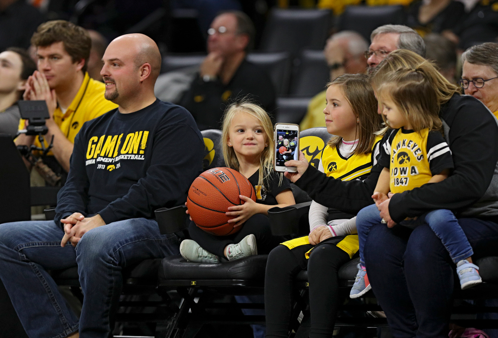 A young fan holds the game ball for the officials between the first and second quarter of Iowa’s overtime win against Princeton at Carver-Hawkeye Arena in Iowa City on Wednesday, Nov 20, 2019. (Stephen Mally/hawkeyesports.com)