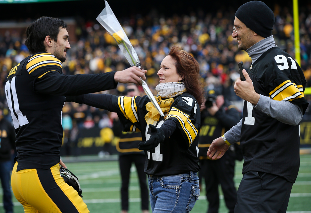 Iowa Hawkeyes placekicker Miguel Recinos (91) is greeted by his parents during Senior Day ceremonies before a game against Nebraska at Kinnick Stadium on November 23, 2018. (Tork Mason/hawkeyesports.com)
