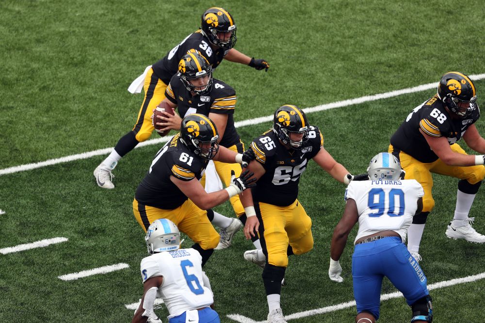 Iowa Hawkeyes quarterback Nate Stanley (4), offensive lineman Cole Banwart (61), offensive lineman Tyler Linderbaum (65), and offensive lineman Landan Paulsen (68) against Middle Tennessee State Saturday, September 28, 2019 at Kinnick Stadium. (Brian Ray/hawkeyesports.com)