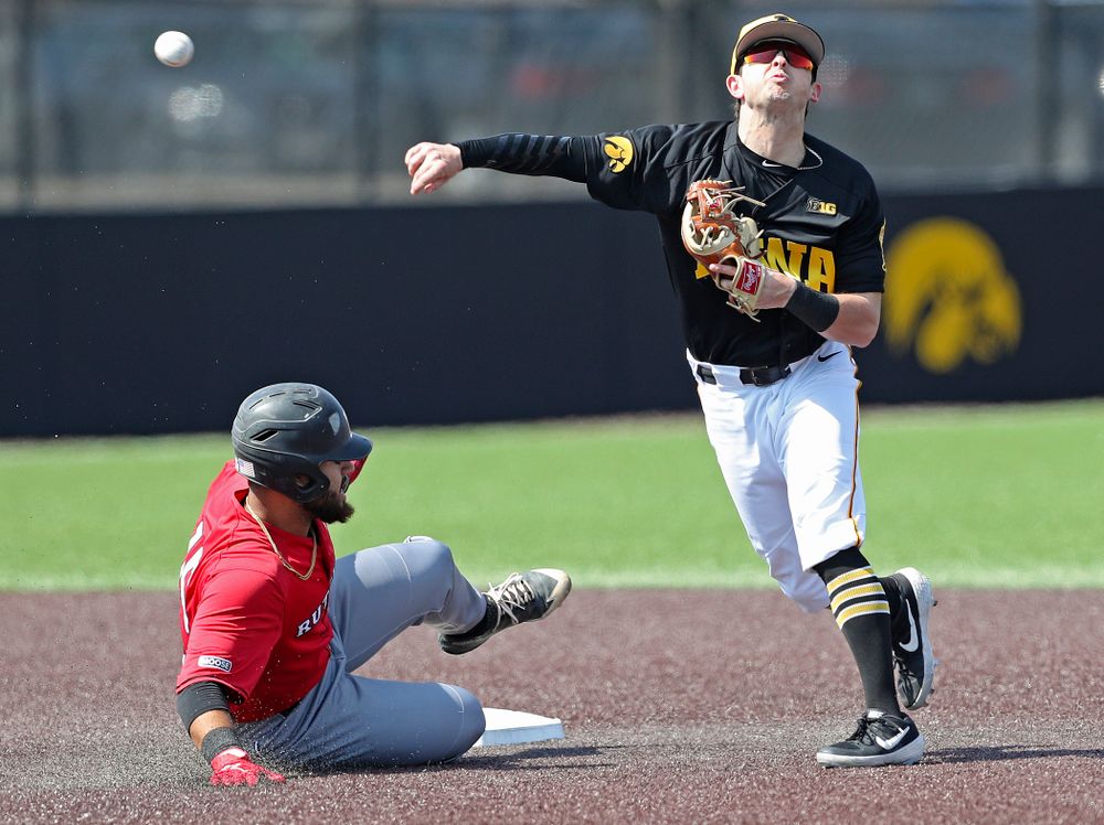 Iowa Hawkeyes second baseman Mitchell Boe (4) throws to first during the first inning of their game against Rutgers at Duane Banks Field in Iowa City on Saturday, Apr. 6, 2019. (Stephen Mally/hawkeyesports.com)
