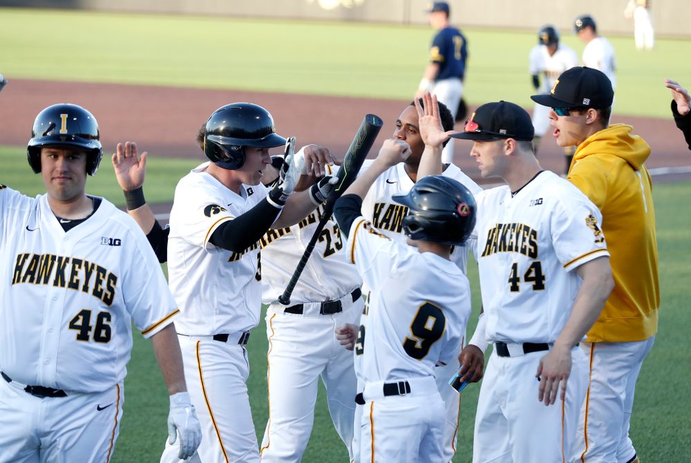 Iowa Hawkeyes infielder Matt Hoeg (3) celebrates with his teammates after scoring against the Michigan Wolverines Friday, April 27, 2018 at Duane Banks Field in Iowa City. (Brian Ray/hawkeyesports.com)