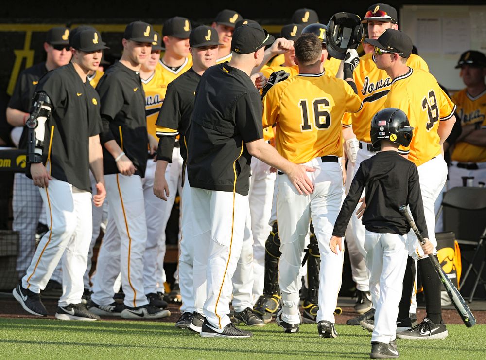 Iowa Hawkeyes shortstop Tanner Wetrich (16) is greeted by teammates after hitting a home run during the fifth inning of their game against Northern Illinois at Duane Banks Field in Iowa City on Tuesday, Apr. 16, 2019. (Stephen Mally/hawkeyesports.com)