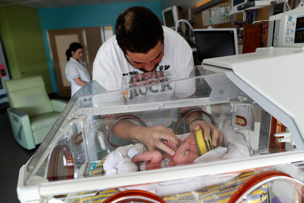 Iowa Hawkeyes offensive lineman Dalton Ferguson (76) and his girlfriend Rachael stand with their newborn twins Ella and Hazel Wednesday, September 12, 2018 in the NICU at the Stead Family Children's Hospital (Brian Ray/hawkeyesports.com)