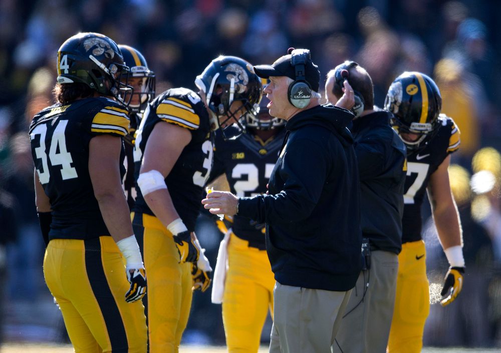 Iowa Hawkeyes defensive line coach Reese Morgan talks with defensive end Nate Meier (34) during the first half of their game against the Northwestern Wildcats Saturday, Nov. 1, 2014 at Kinnick Stadium. (Brian Ray/hawkeyesports.com)