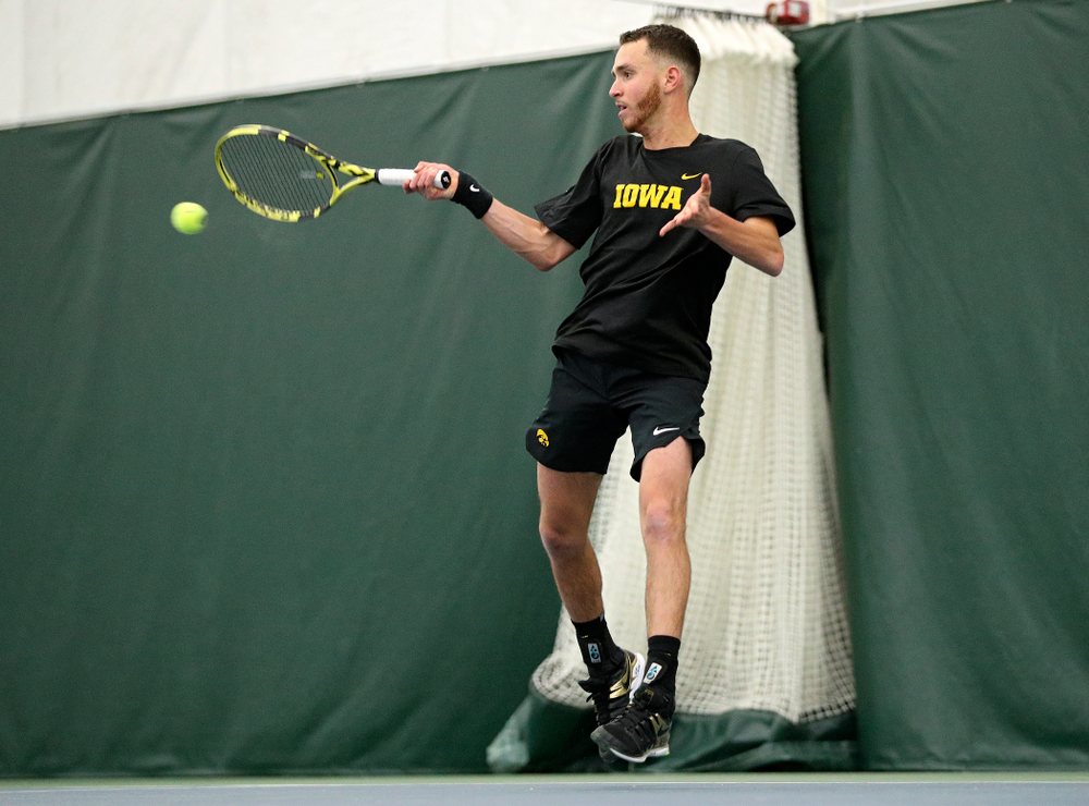 Iowa’s Kareem Allaf returns a shot during his singles match at the Hawkeye Tennis and Recreation Complex in Iowa City on Friday, February 14, 2020. (Stephen Mally/hawkeyesports.com)