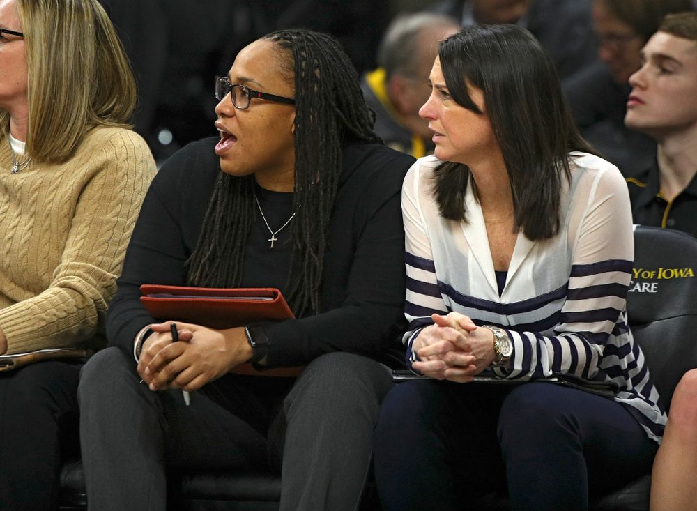 Iowa assistant coach Raina Harmon (from left) talks with assistant coach Abby Stamp during the fourth quarter of the game at Carver-Hawkeye Arena in Iowa City on Thursday, February 6, 2020. (Stephen Mally/hawkeyesports.com)