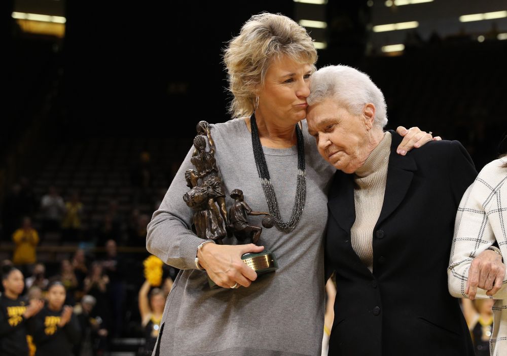 Former University of Iowa Director of Intercollegiate Athletics for Women Dr. Christine Grant receives her trophy for being inducted into the WomenÕs Basketball Hall of Fame from Iowa Hawkeyes head coach Lisa Bluder and director of basketball operations Kathryn Reynolds
before their game against the Robert Morris Colonials Sunday, December 2, 2018 at Carver-Hawkeye Arena. (Photo by Brian Ray)