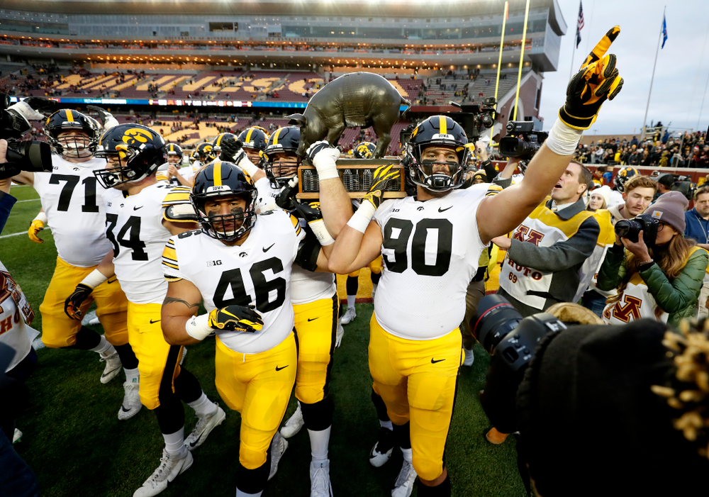 The Iowa Hawkeyes celebrate with the Floyd of Rosedale trophy following their win over the Minnesota Golden Gophers Saturday, October 6, 2018 at TCF Bank Stadium. (Brian Ray/hawkeyesports.com)