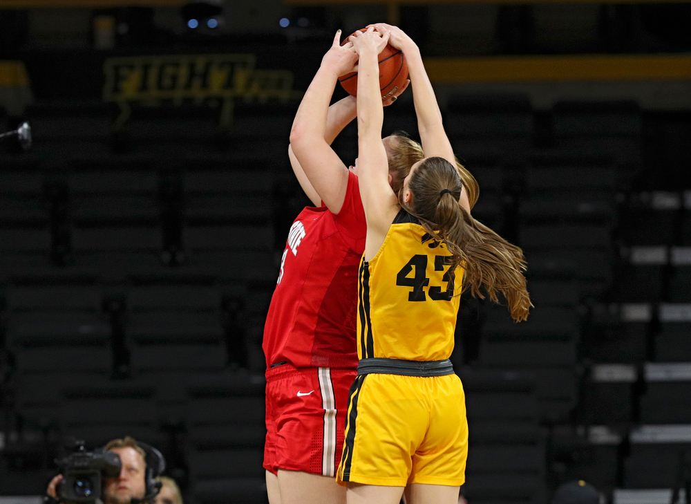Iowa Hawkeyes forward Amanda Ollinger (43) blocks a shot by Ohio State Buckeyes forward Rebeka Mikulasikova (23) during the third quarter of their game at Carver-Hawkeye Arena in Iowa City on Thursday, January 23, 2020. (Stephen Mally/hawkeyesports.com)