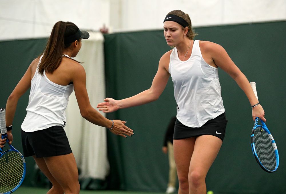 Iowa’s Ashleigh Jacobs (right) celebrates with Michelle Bacalla during their doubles match at the Hawkeye Tennis and Recreation Complex in Iowa City on Sunday, February 23, 2020. (Stephen Mally/hawkeyesports.com)