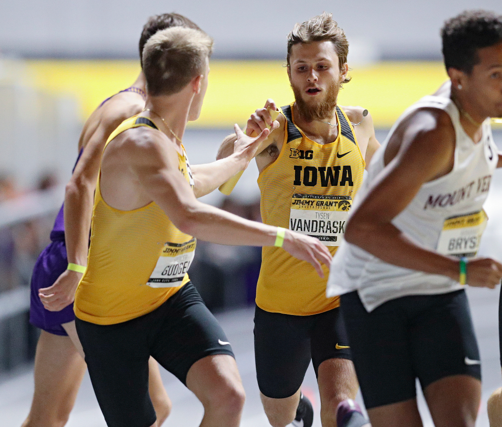 Iowa’s Tysen VanDraska (right) hands the baton to Spencer Gudgel as they run the men’s 1600 meter relay event during the Jimmy Grant Invitational at the Recreation Building in Iowa City on Saturday, December 14, 2019. (Stephen Mally/hawkeyesports.com)