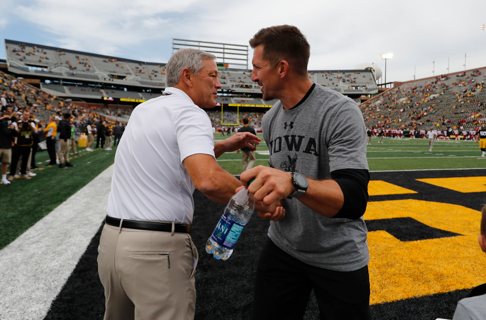 Iowa Hawkeyes head coach Kirk Ferentz shakes hands with Dallas Clark before their game against the Iowa State Cyclones Saturday, September 8, 2018 at Kinnick Stadium. (Brian Ray/hawkeyesports.com)