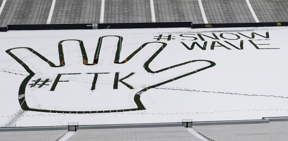 Members of the Iowa Athletics Turf Management staff create the #SnowWave for kids in the Stead Family Children's Hospital Thursday, February