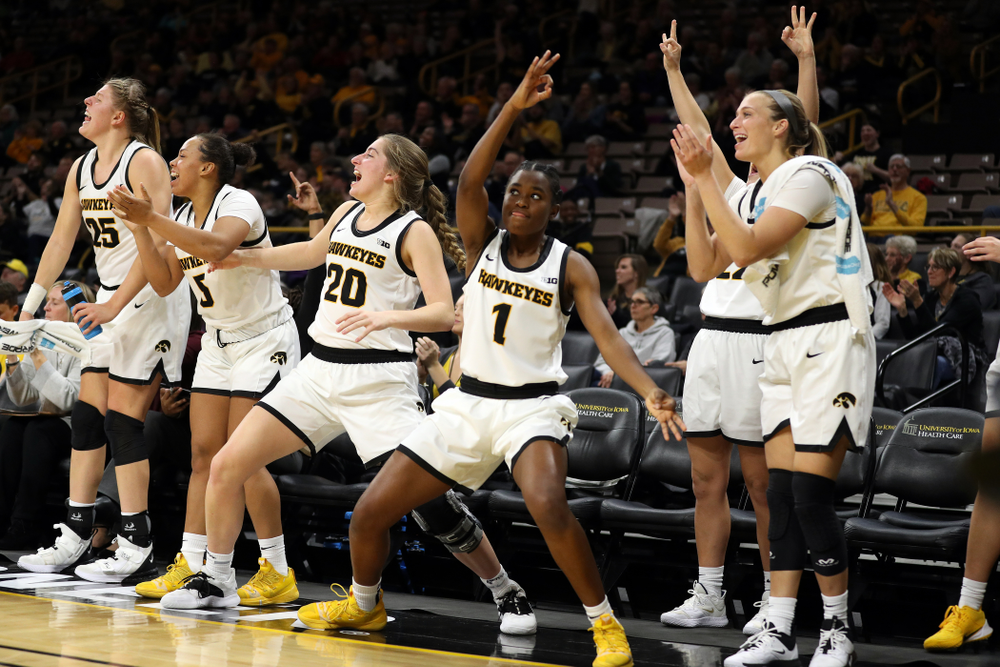 Iowa Hawkeyes guard Kate Martin (20) and guard Tomi Taiwo (1) celebrate a three point basket by guard Megan Meyer (11) against Florida Atlantic University Thursday, November 7, 2019 at Carver-Hawkeye Arena. (Brian Ray/hawkeyesports.com)