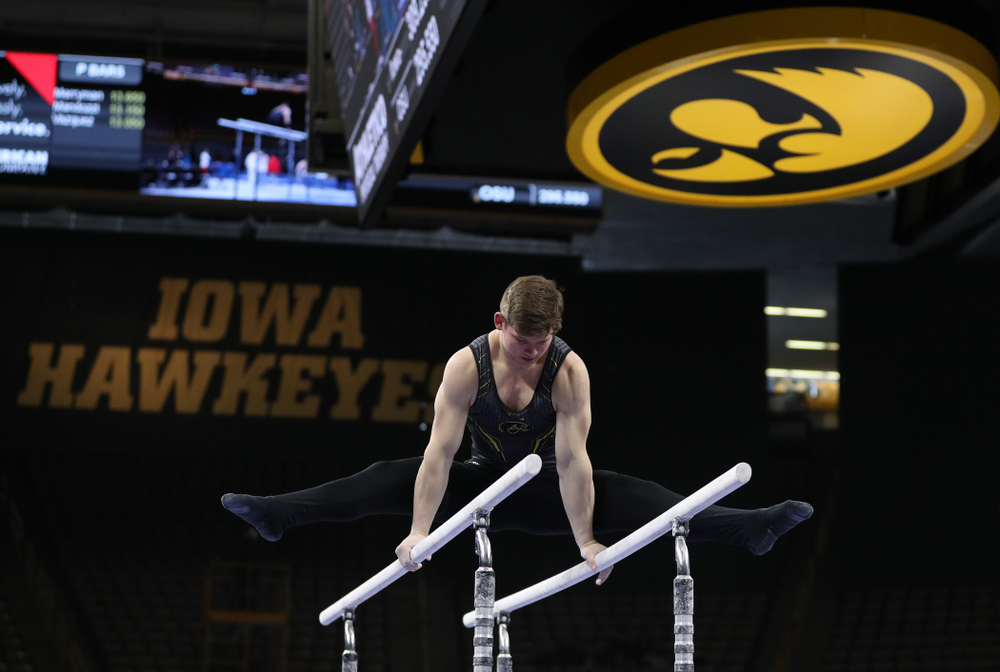 Iowa's Stewart Brown competes on the parallel bars against the Ohio State Buckeyes Saturday, March 16, 2019 at Carver-Hawkeye Arena. (Brian Ray/hawkeyesports.com)