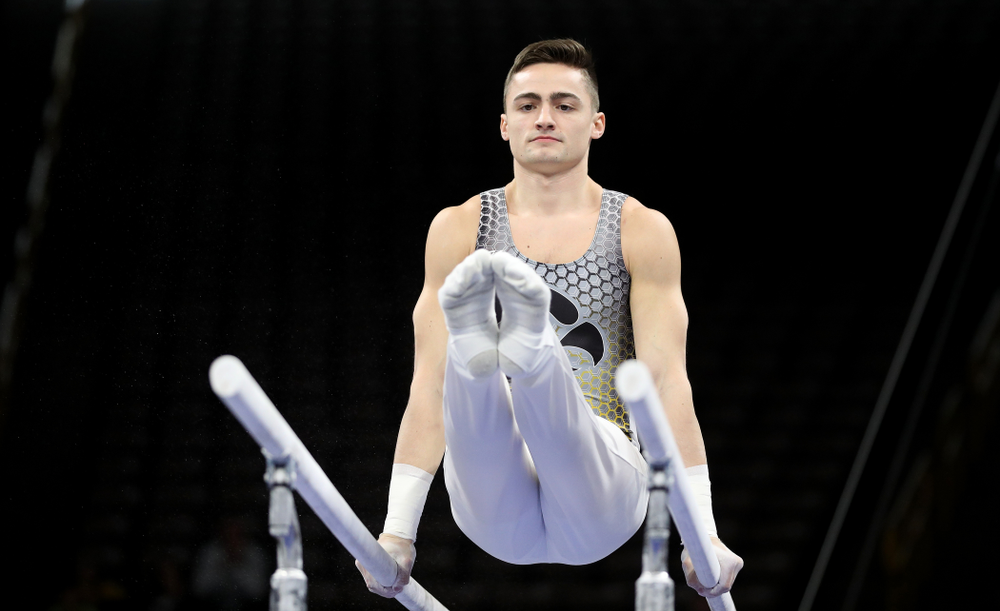 Iowa’s Mitch Mandozzi competes on the parallel bars against Illinois Sunday, March 1, 2020 at Carver-Hawkeye Arena. (Brian Ray/hawkeyesports.com)