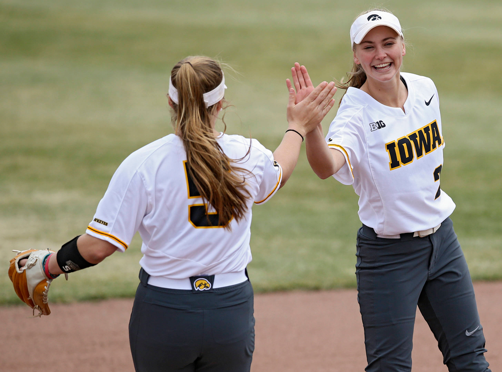 Iowa Hawkeyes Sydney Owens (5) gets a high-five from Aralee Bogar (2) as she takes the field before their Big Ten Conference softball game at Pearl Field in Iowa City on Friday, Mar. 29, 2019. (Stephen Mally/hawkeyesports.com)