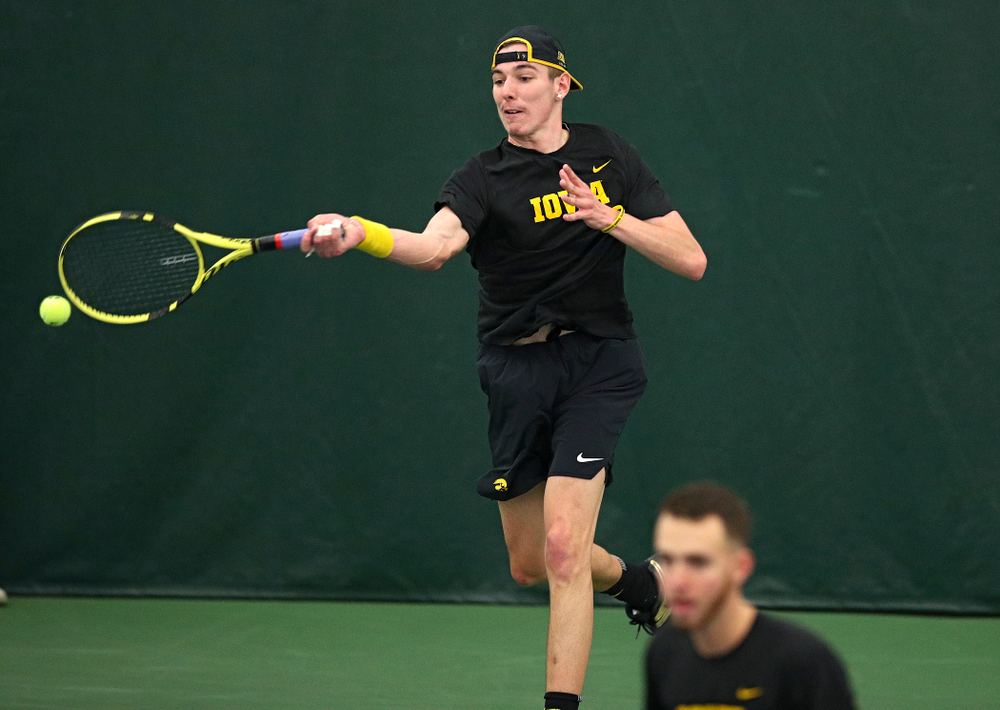Iowa’s Nikita Snezhko (top) returns a shot as Kareem Allaf looks on during their doubles match at the Hawkeye Tennis and Recreation Complex in Iowa City on Friday, March 6, 2020. (Stephen Mally/hawkeyesports.com)