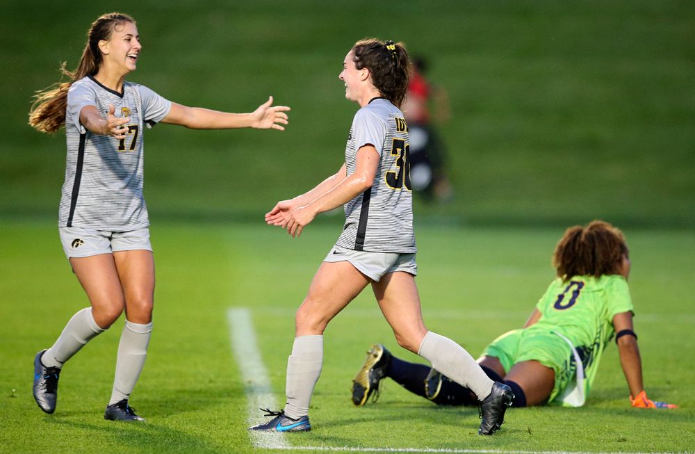 Iowa defender Hannah Drkulec (17) celebrates with forward Devin Burns (30) after Burns scored a goal during the first half of their match at the Iowa Soccer Complex in Iowa City on Friday, Sep 13, 2019. (Stephen Mally/hawkeyesports.com)