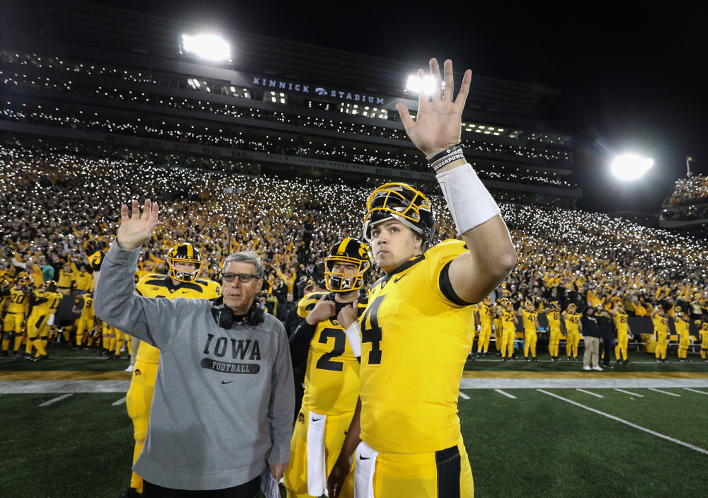 Iowa Hawkeyes quarterback Nate Stanley (4) and quarterbacks coach Ken O'Keefe wave to the Stead Family ChildrenÕs Hospital against the Penn State Nittany Lions Saturday, October 12, 2019 at Kinnick Stadium. (Brian Ray/hawkeyesports.com)