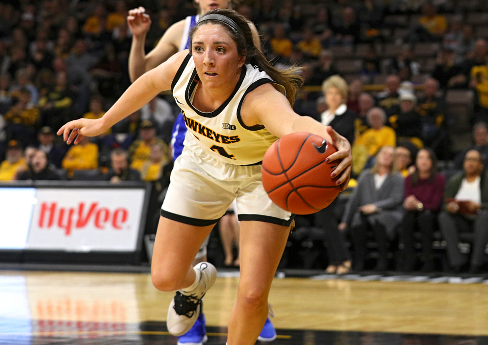 Iowa Hawkeyes guard Mckenna Warnock (14) saves a ball from going out of bounds during the fourth quarter of their game at Carver-Hawkeye Arena in Iowa City on Saturday, December 21, 2019. (Stephen Mally/hawkeyesports.com)