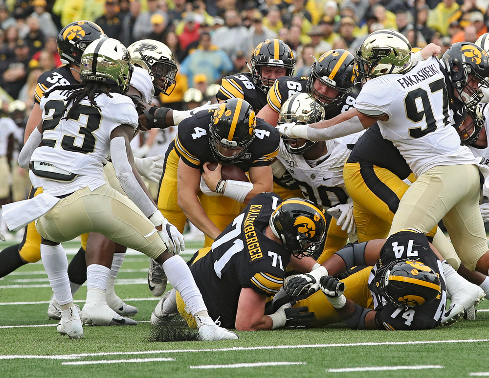 Iowa Hawkeyes quarterback Nate Stanley (4) dives ahead for yards on a run during the first quarter of their game at Kinnick Stadium in Iowa City on Saturday, Oct 19, 2019. (Stephen Mally/hawkeyesports.com)