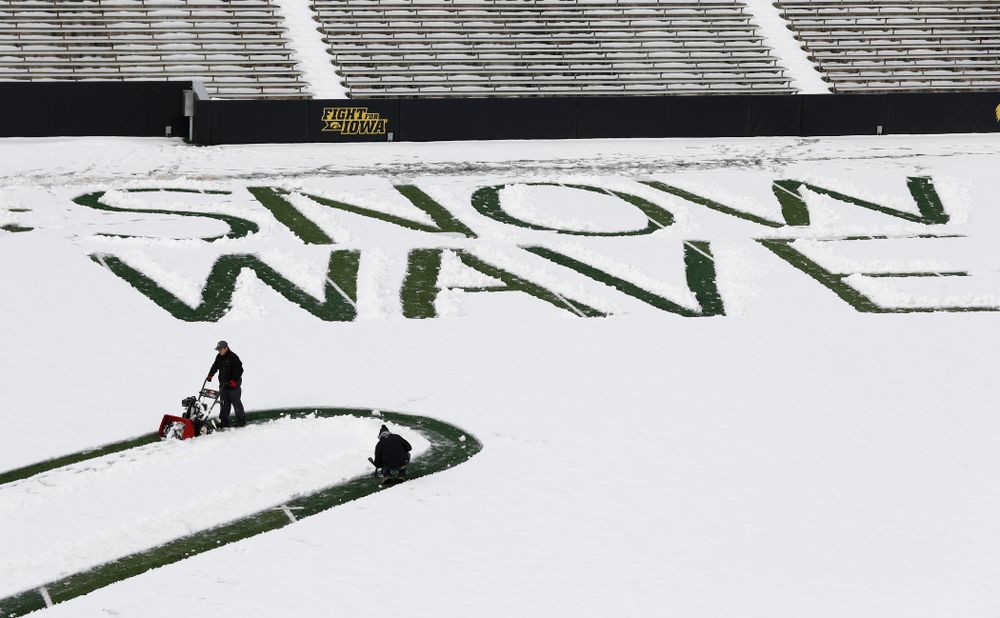 Members of the Iowa Athletics Turf Management staff create the #SnowWave for kids in the Stead Family Children's Hospital Thursday, February