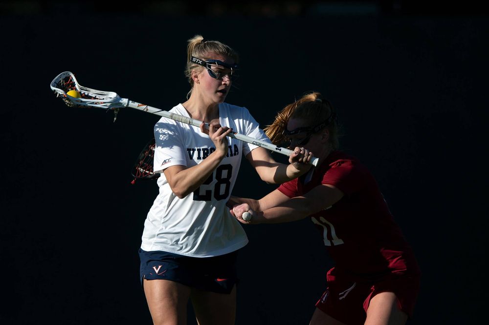 STANFORD, California - FEBRUARY 14: Virginia Cavaliers midfield Nora Bowen (28) is defended by Stanford Cardinal defense Maggie Bellaschi (11) during the first half at Cagan Stadium on February 14, 2020 in Stanford, California. The Virginia Cavaliers defeated the Stanford Cardinal 12-11. (Photo by Jason O. Watson)
