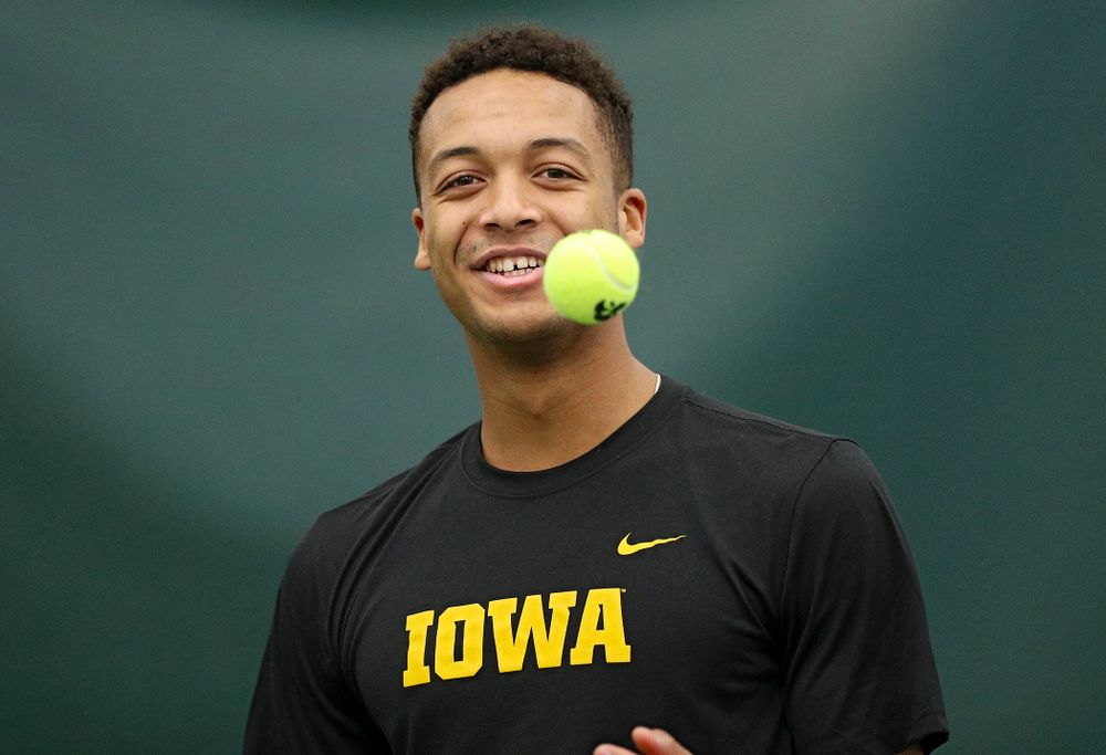 Iowa’s Oliver Okonkwo tosses a ball before serving during his match against Marquette at the Hawkeye Tennis and Recreation Complex in Iowa City on Saturday, January 25, 2020. (Stephen Mally/hawkeyesports.com)