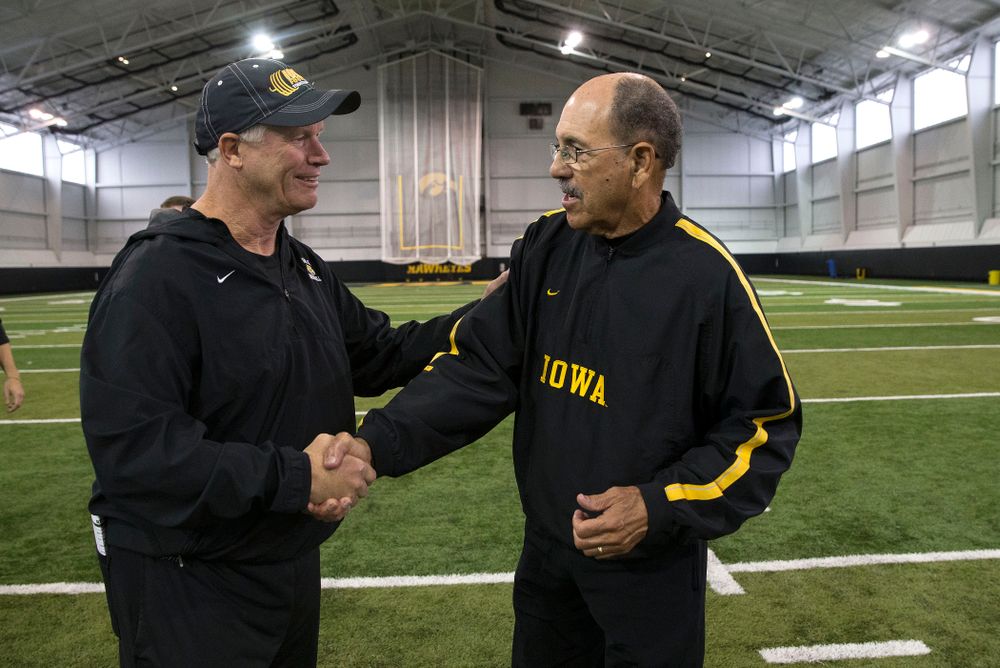Iowa Hawkeyes defensive line coach Reese Morgan talks with former running backs coach Carl Jackson following their walk through Friday, Oct. 10, 2014 on the indoor field of the Hayden Fry Football Campus. (Brian Ray/hawkeyesports.com)