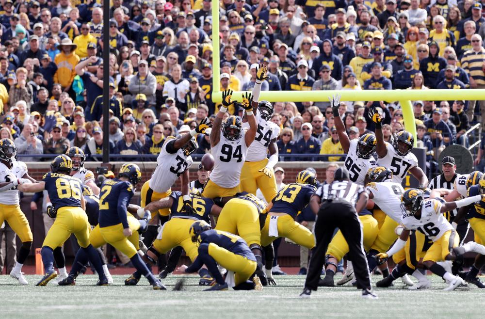 Iowa Hawkeyes linebacker Djimon Colbert (32), defensive end A.J. Epenesa (94), and defensive end Chauncey Golston (57) against the Michigan Wolverines Saturday, October 5, 2019 at Michigan Stadium in Ann Arbor, MI. (Brian Ray/hawkeyesports.com)