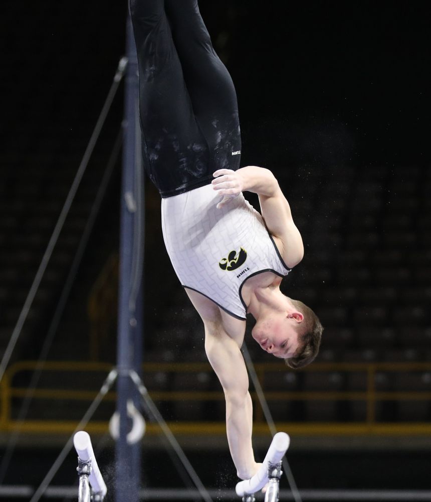 Iowa's Stewart Brown competes on the parallel bars against UIC and Minnesota Saturday, February 2, 2019 at Carver-Hawkeye Arena. (Brian Ray/hawkeyesports.com)